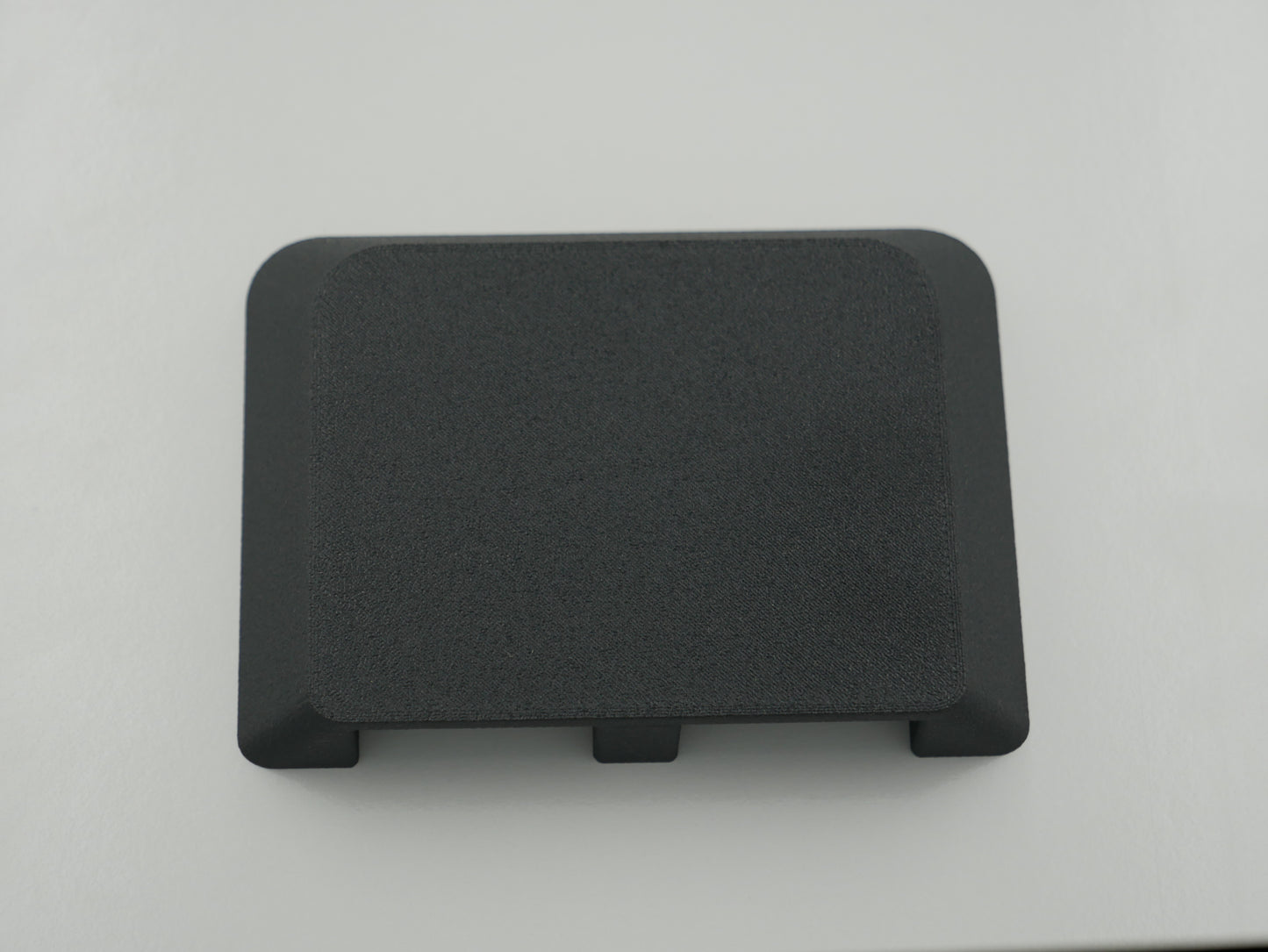 Black rectangular object on a light gray background
