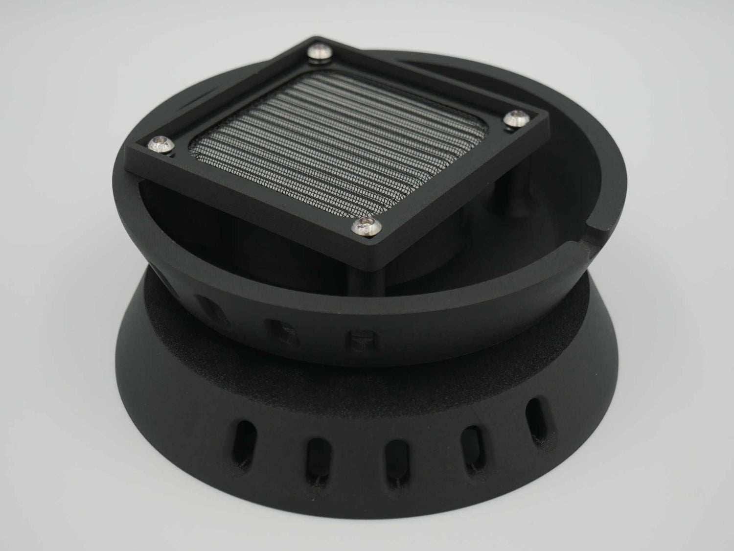 Black circular canopy vent with square metal mesh screen and mounting holes for ute canopies