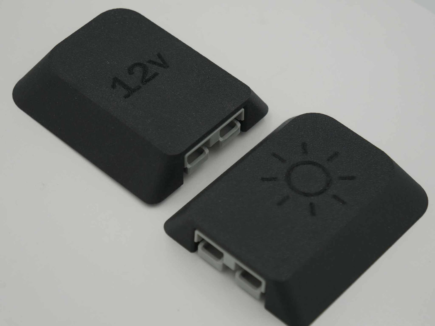 two black Single Anderson Mount 50amp plugs with 12v and sun icons on top, made from durable ABS-Glass Fiber