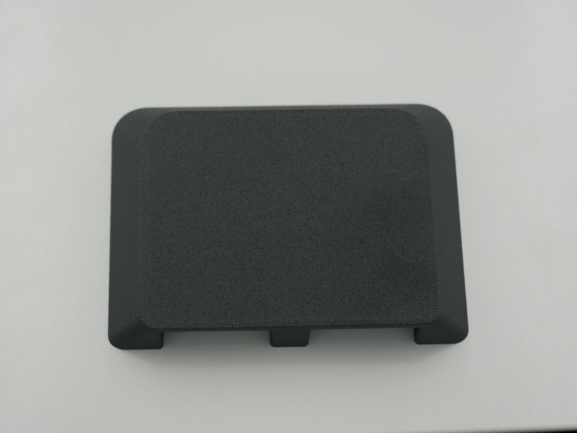Black rectangular object on a light gray background