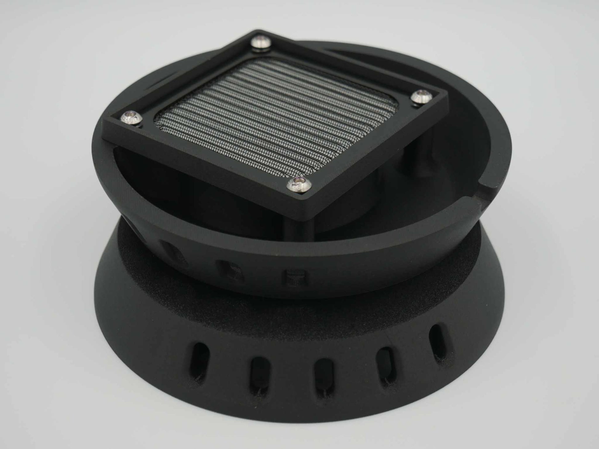 Black circular canopy vent with square metal mesh screen and mounting holes for ute canopies