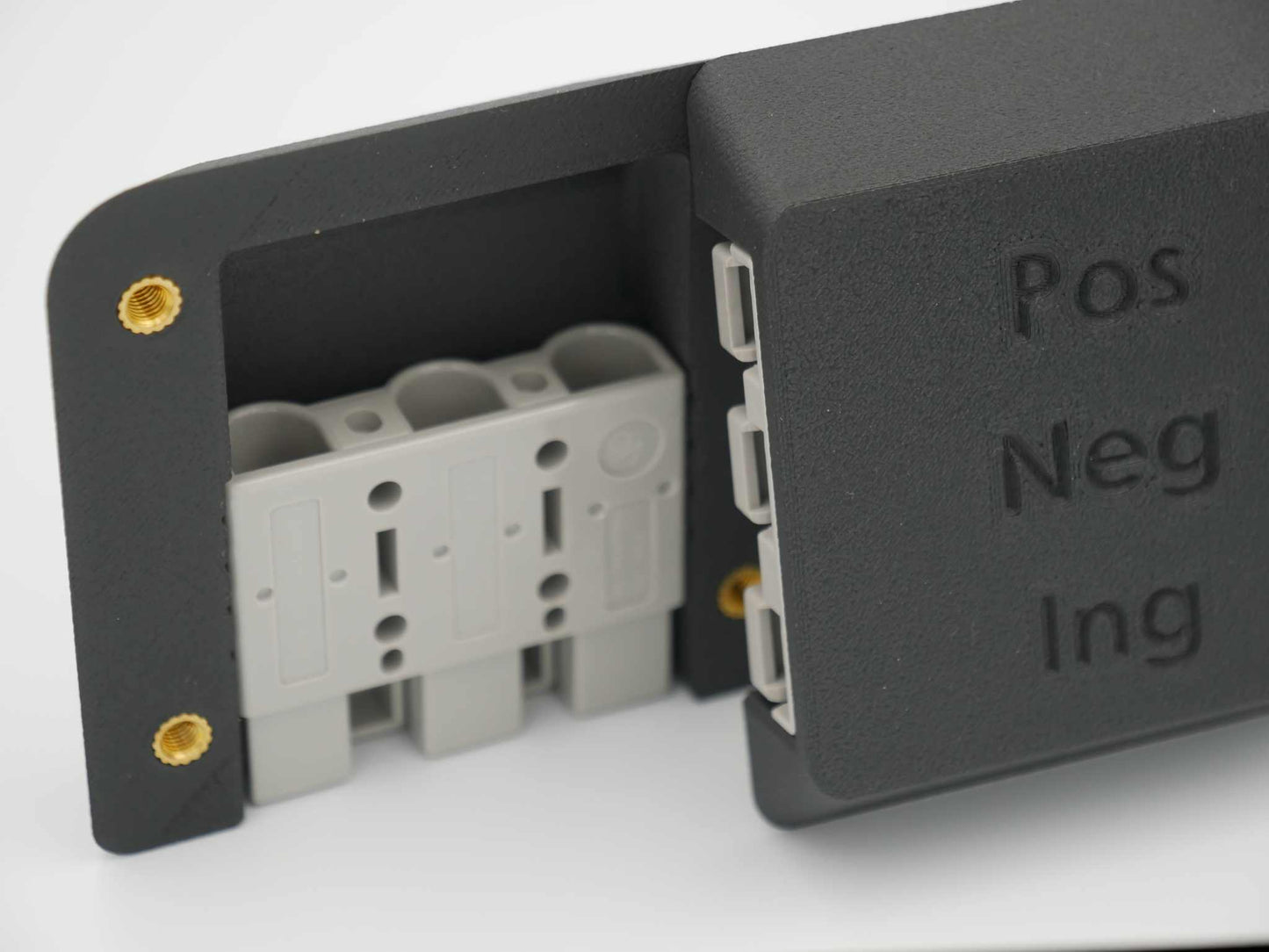 Close-up of a black Triple Anderson Mount with Pos, Neg, Ing labels for 12V system connections